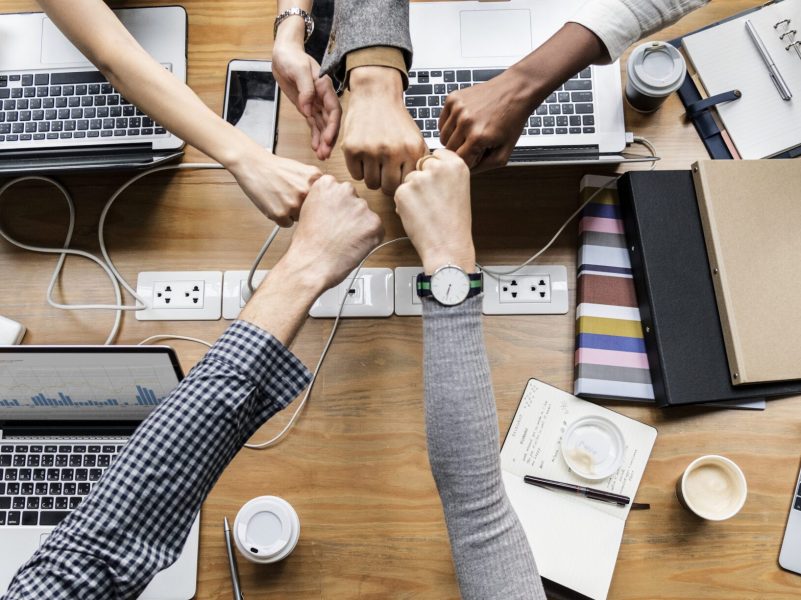 Colleagues giving a fist bump Colleagues giving a fist bump